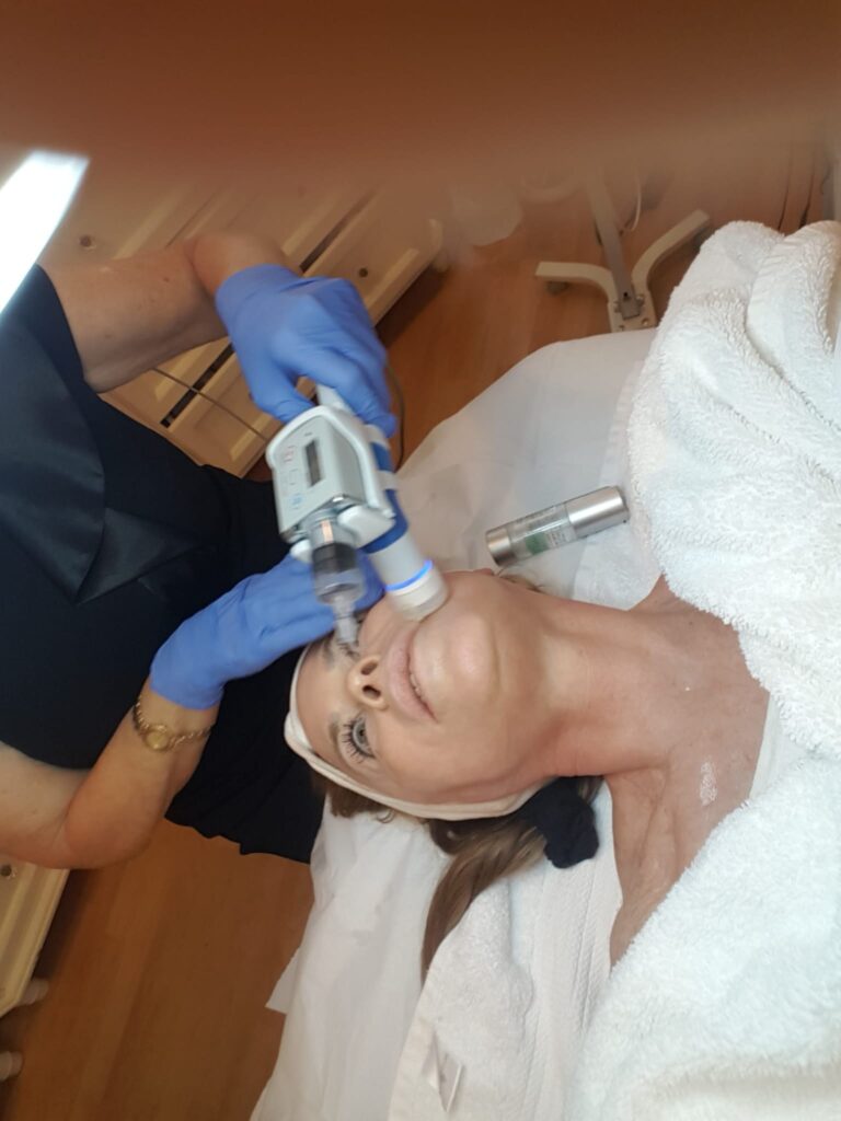 Eva Taub giving a hands-on European skin treatment at her Bay Harbor Islands studio